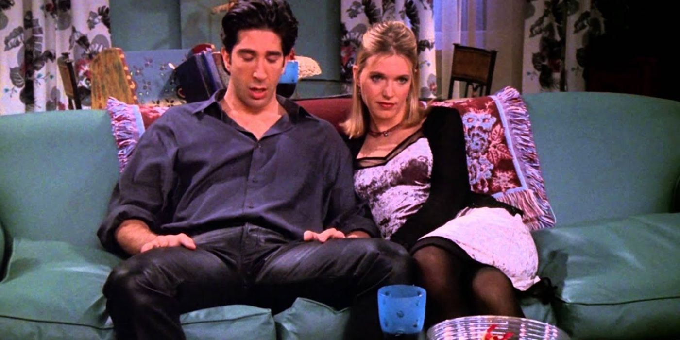 Ross sitting on the couch with his date and his leather pants on Friends
