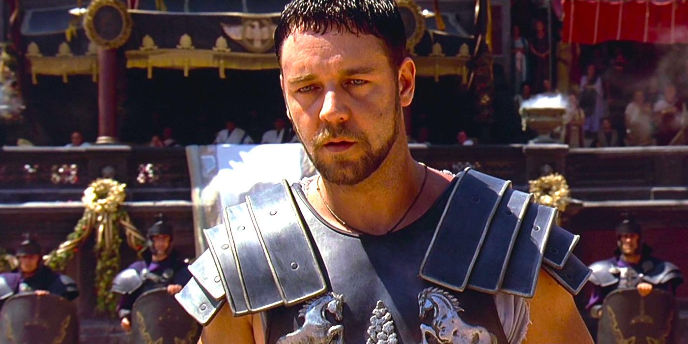 Russell Crowe as Maximus in Gladiator wearing armor in the arena, looking stricken