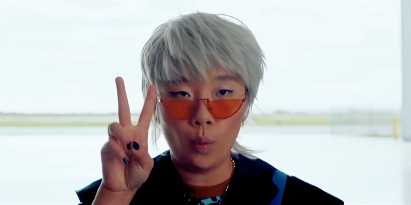 Sabrina Wu as Deadeye holding up the Peace Sign and wearing orange sunglasses in Joy Ride