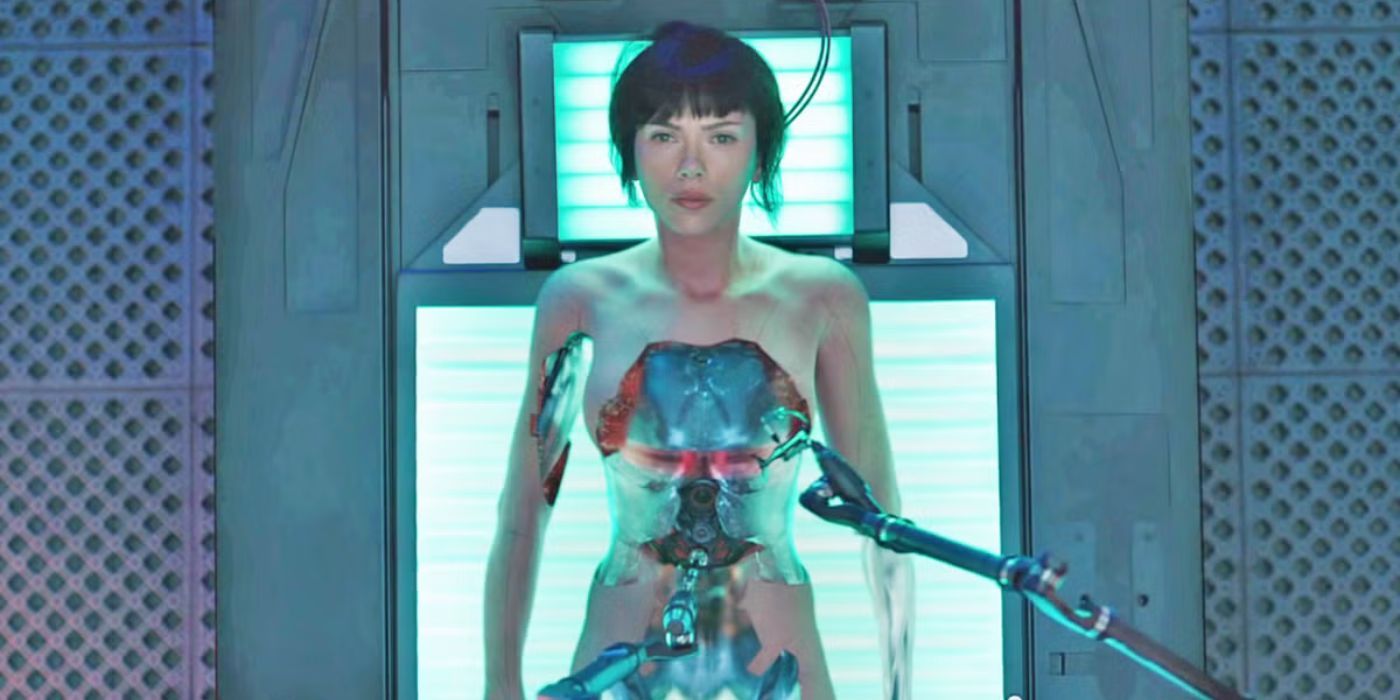 Scarlett Johansson laying on a bed while machines work on restructuring her body in Ghost in the Shell