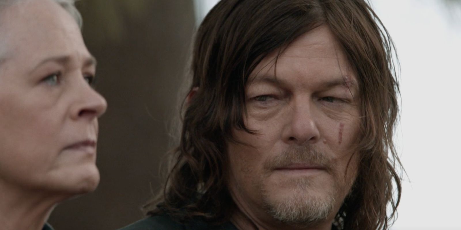 Daryl looking at a sad Carol in The Walking Dead season 11 episode 24
