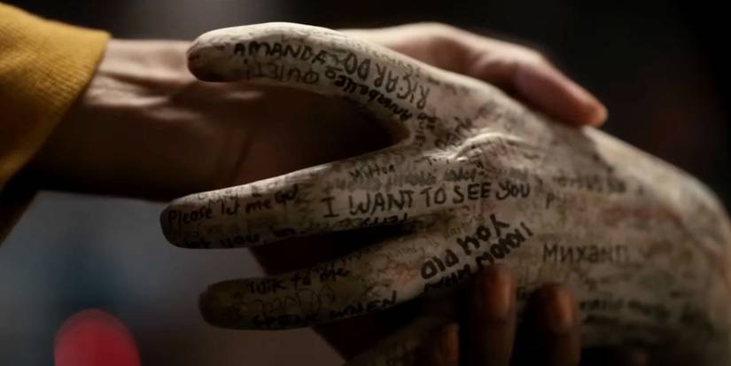 The hand from Talk to Me grasping Mia's hand.