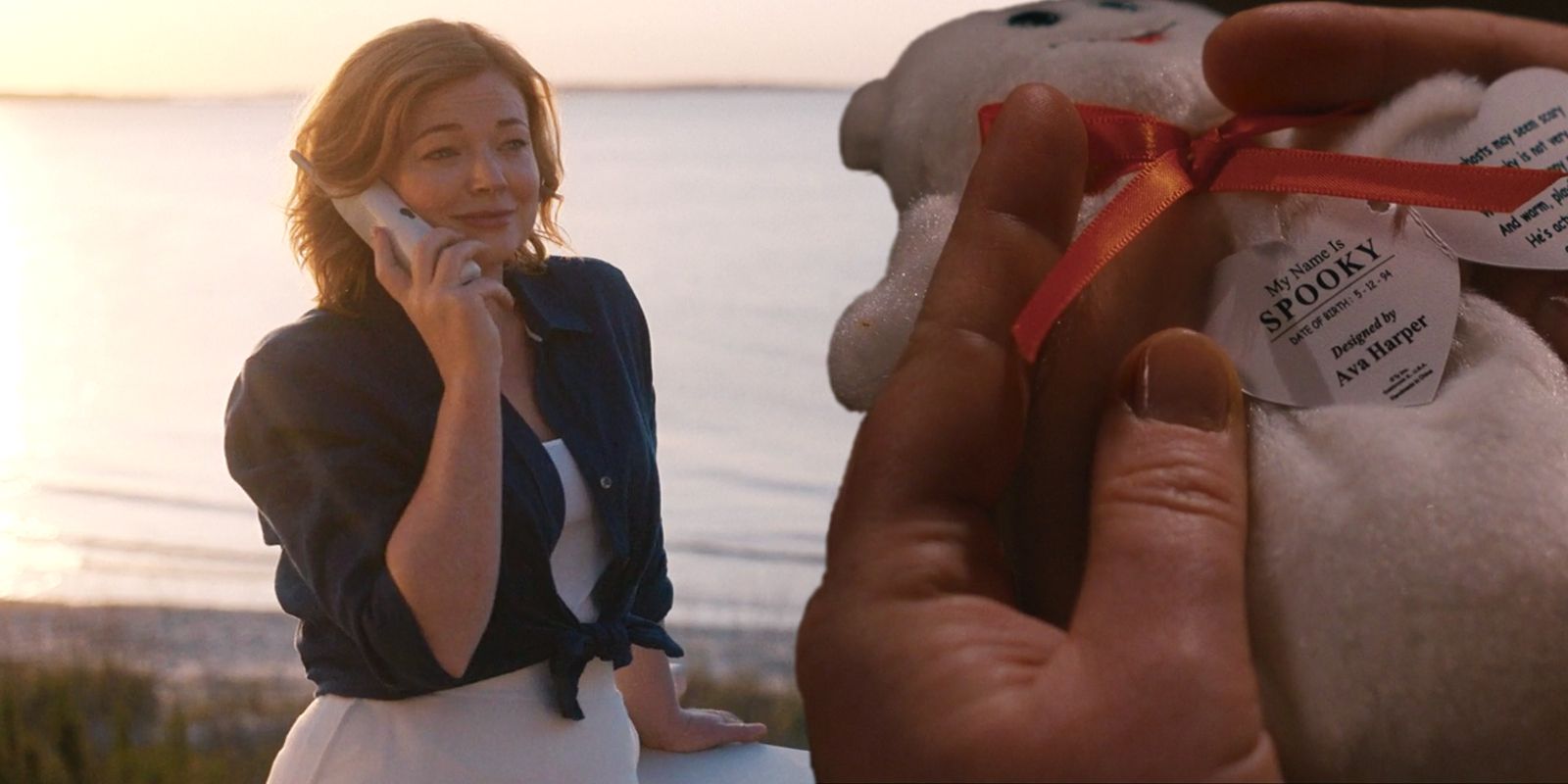 This image shows Sheila talking on the phone in front of the ocean next to a cutout of Spooky the Ghost.