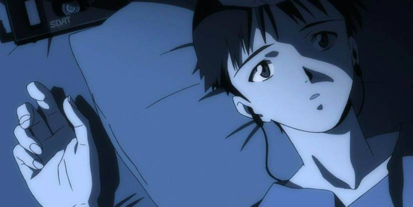 Shinji from Neon Genesis Evangelion lying in bed with headphones in and a blank expression.