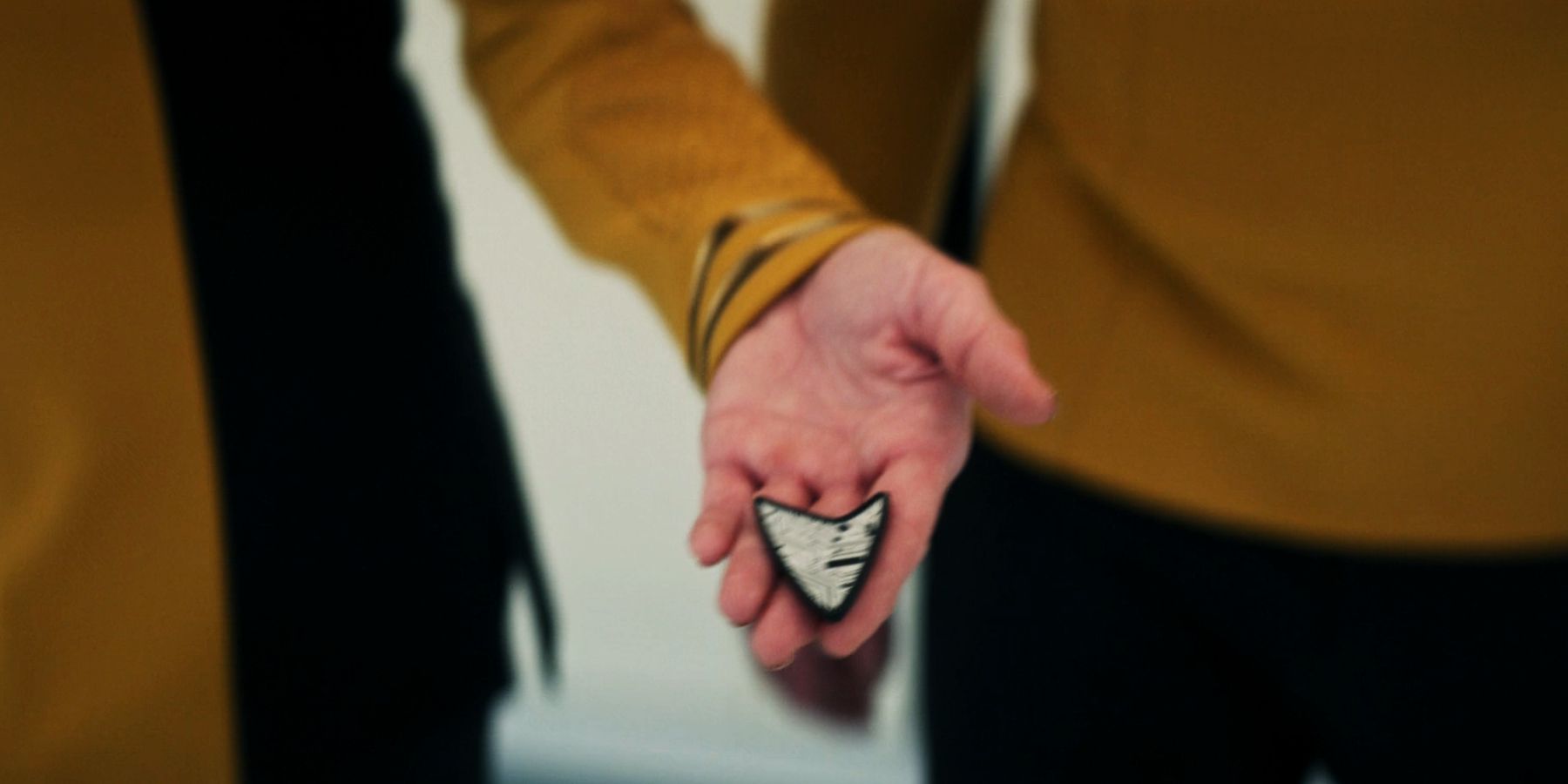Number One and Captain Pike check Boimler&rsquo;s communicator badge