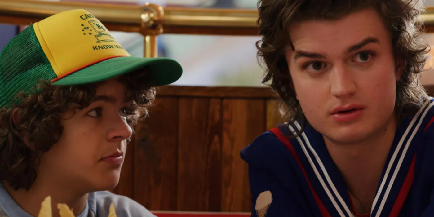 Steve And Dustin In a Yellow Cap Looking At Each Other