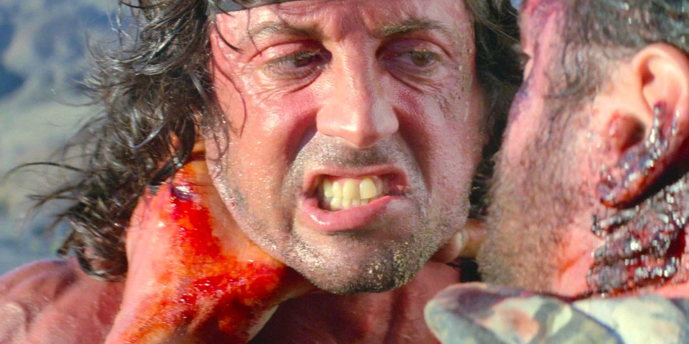 Sylvester Stallone in Rambo 3 fighting at close quarters with a bloodied enemy