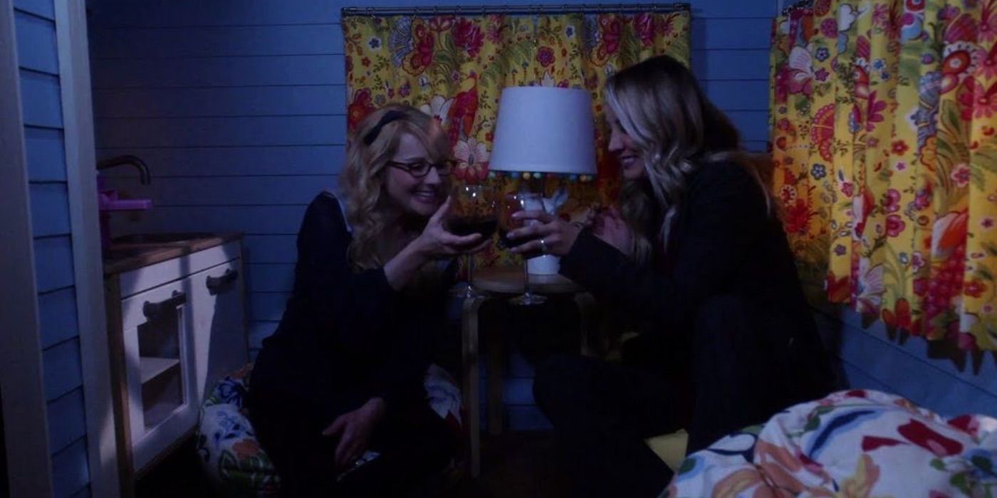 Bernadette and Penny drink win in a playhouse in the Big Bang Theory 