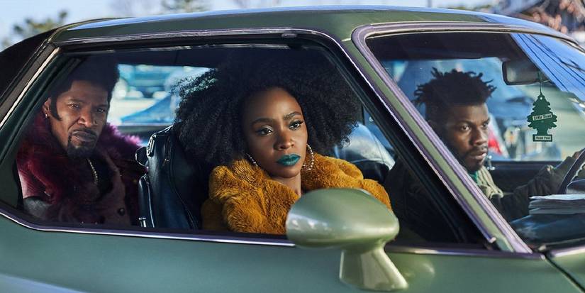 Yo-Yo driving by in a car with Slick and Fontaine in They Cloned Tyrone