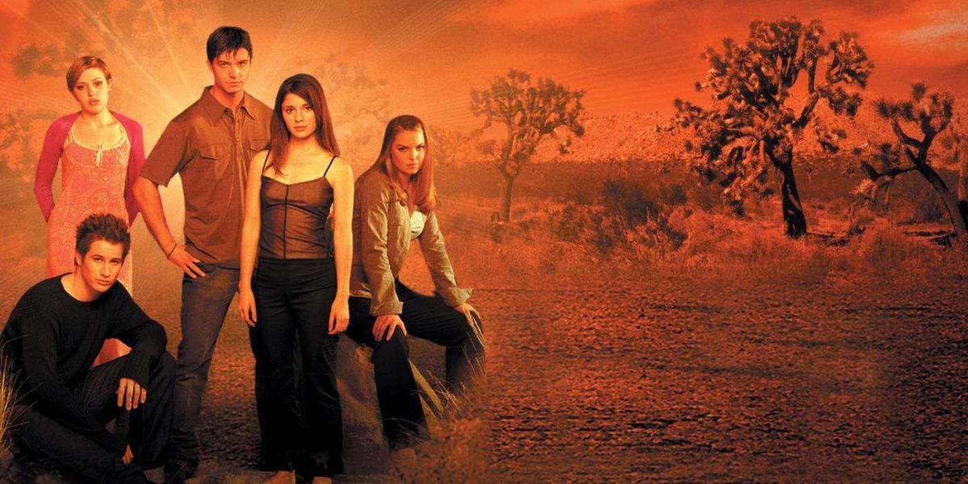 The cast of Roswell posing together with the desert in the background