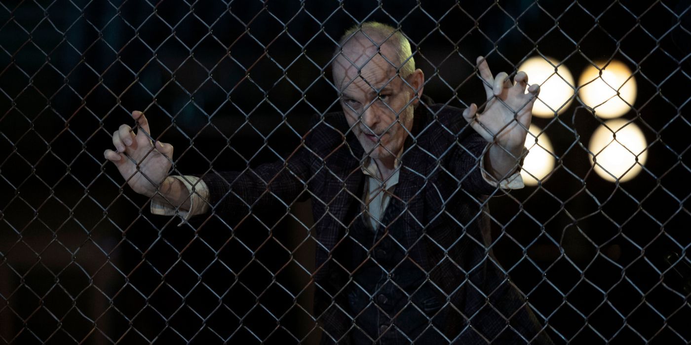 The Croat leans against chainlink fence in The Walking Dead Dead City