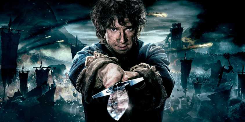 Martin Freeman as Bilbo Baggins holding a sword in The Hobbit.
