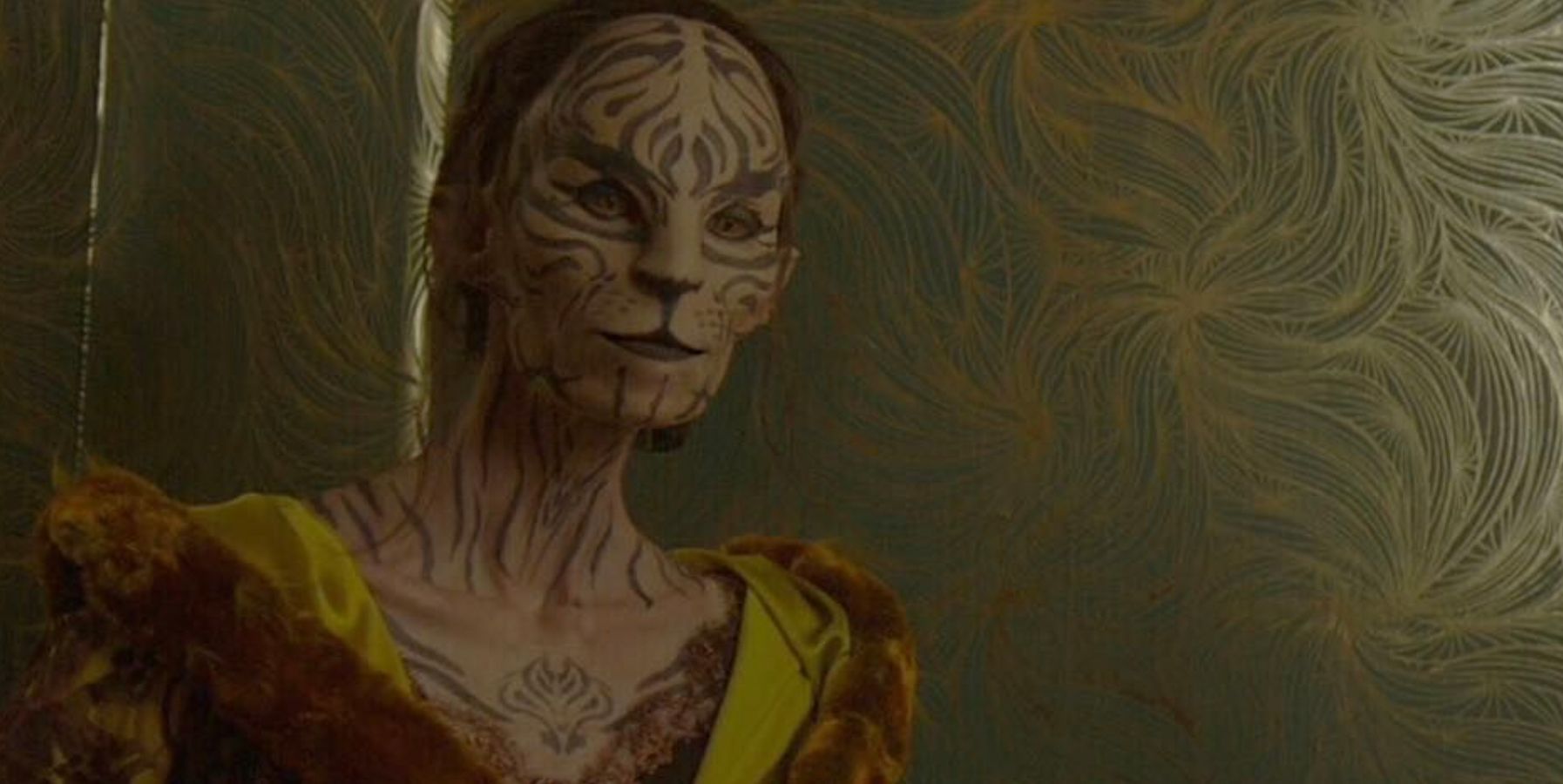 Tigris with her feline markings when she first meets Katniss in Hunger Games Mockingjay