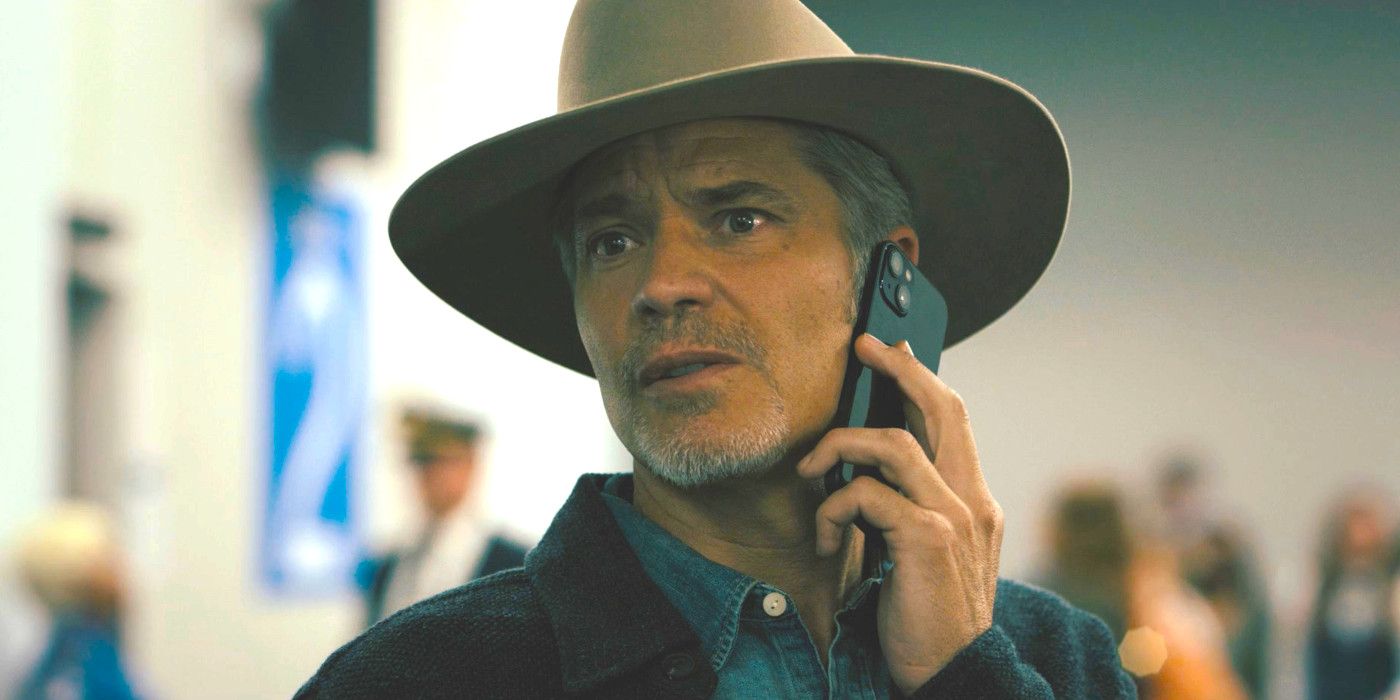 Timothy Olyphant as Raylan Givens in Justified City Primeval looking concerned while talking on a cell phone in a crowd