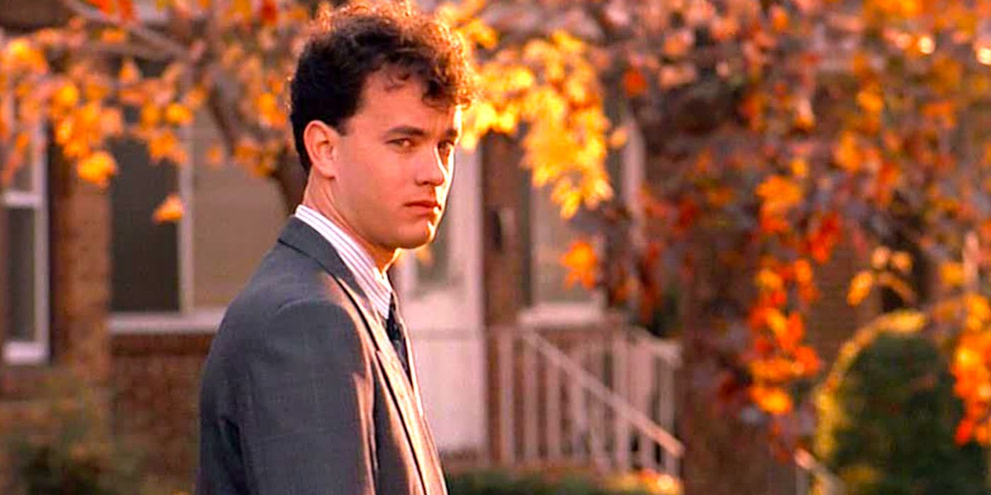 Tom Hanks as Josh in Big looking sad standing on a sidewalk amid colorful autumn leaves