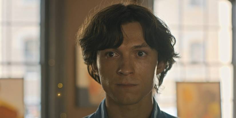 Danny (Tom Holland) looking at the fireflies in his paintings in The Crowded Room