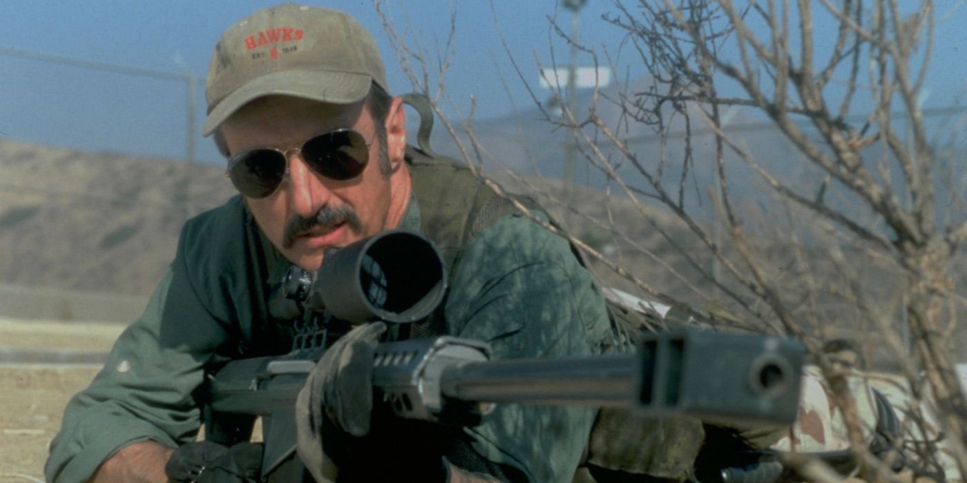 Burt aims a large rifle in the Tremors TV series 