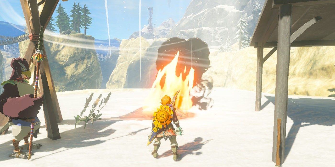Link menyaksikan ledakan api dan angin yang disebabkan oleh pembakaran Kerucut Pinus Hylian di api unggun di luar Desa Rito di The Legend of Zelda: Air Mata Kerajaan.