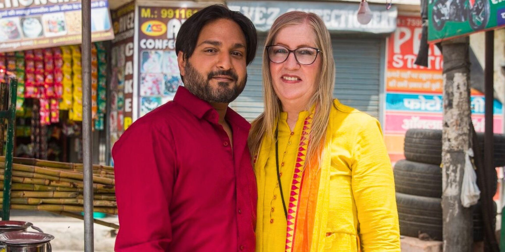 90 Day Fiance's Jenny Slatten and Sumit Singh posing in front of a storefront