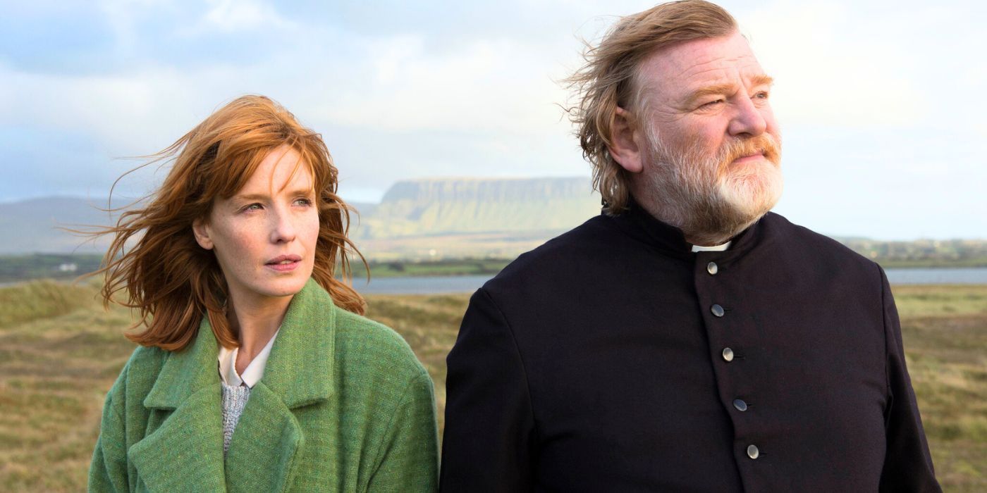 Kelly Reilly standing with Brendan Gleeson in a field in Calvary