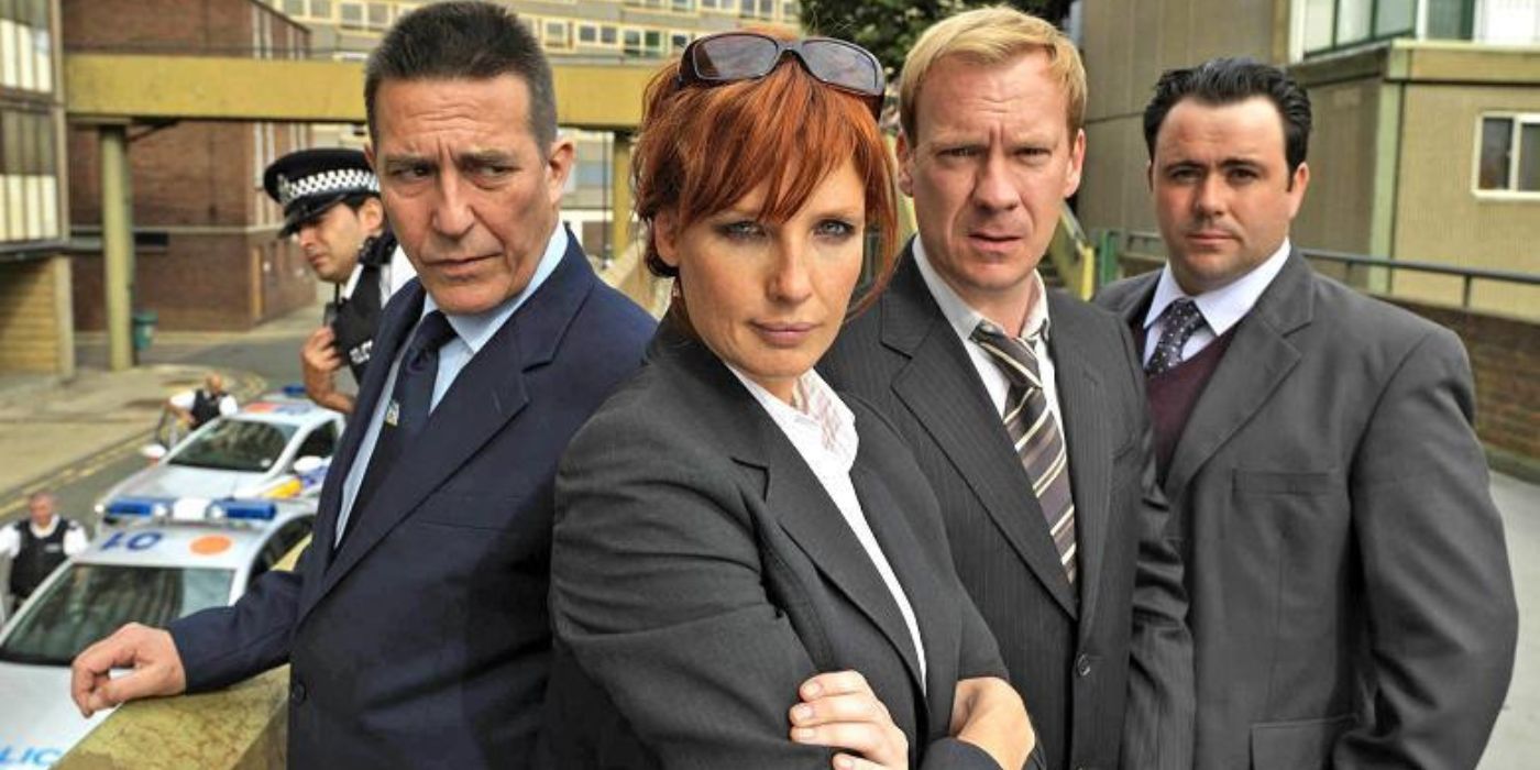 Kelly Reilly standing with her arms crossed with male detectives behind her in Above Suspicion