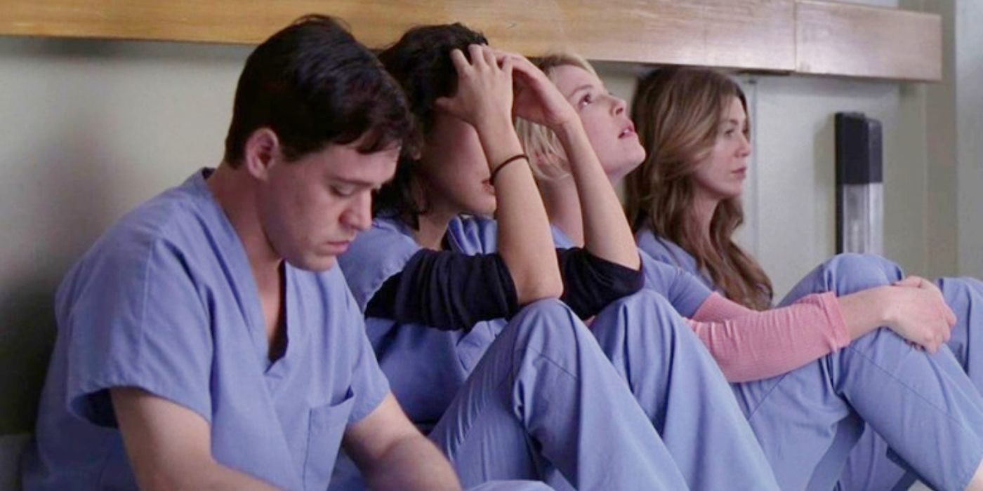 An image of Meredith, Izzie, Cristina, and George sitting in the hallway in Grey's Anatomy