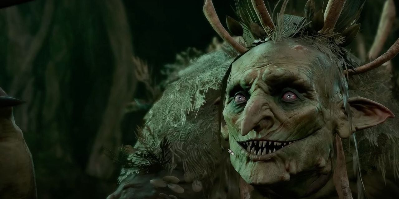 Auntie Ethel's hag form in Baldur's Gate 3 smiles with her sharp teeth and pale green skin.