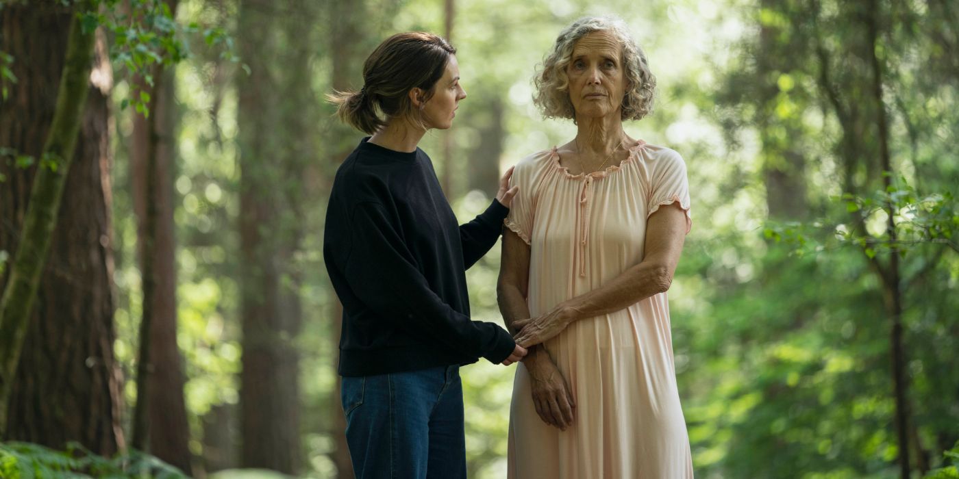 Barbara Marten as Sylvia Chambers standing in a nighgown in the woods being comforted by Lucy Chambers in The Devil's Hour.