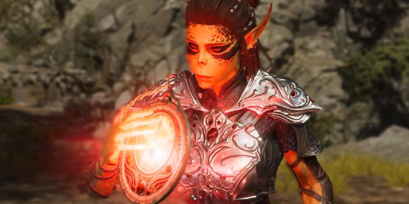 Lae'zel, the githyanki companion in Baldur's Gate 3 with pointed ears and painted face, holds a circular device in her hand. It glows with red light.