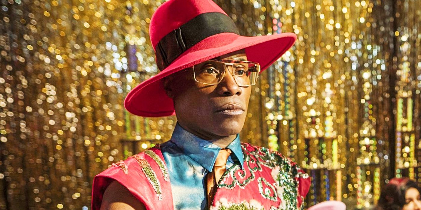 Pray Tell (Billy Porter) stands on stage with trophies and gold streamers in the background in Pose.