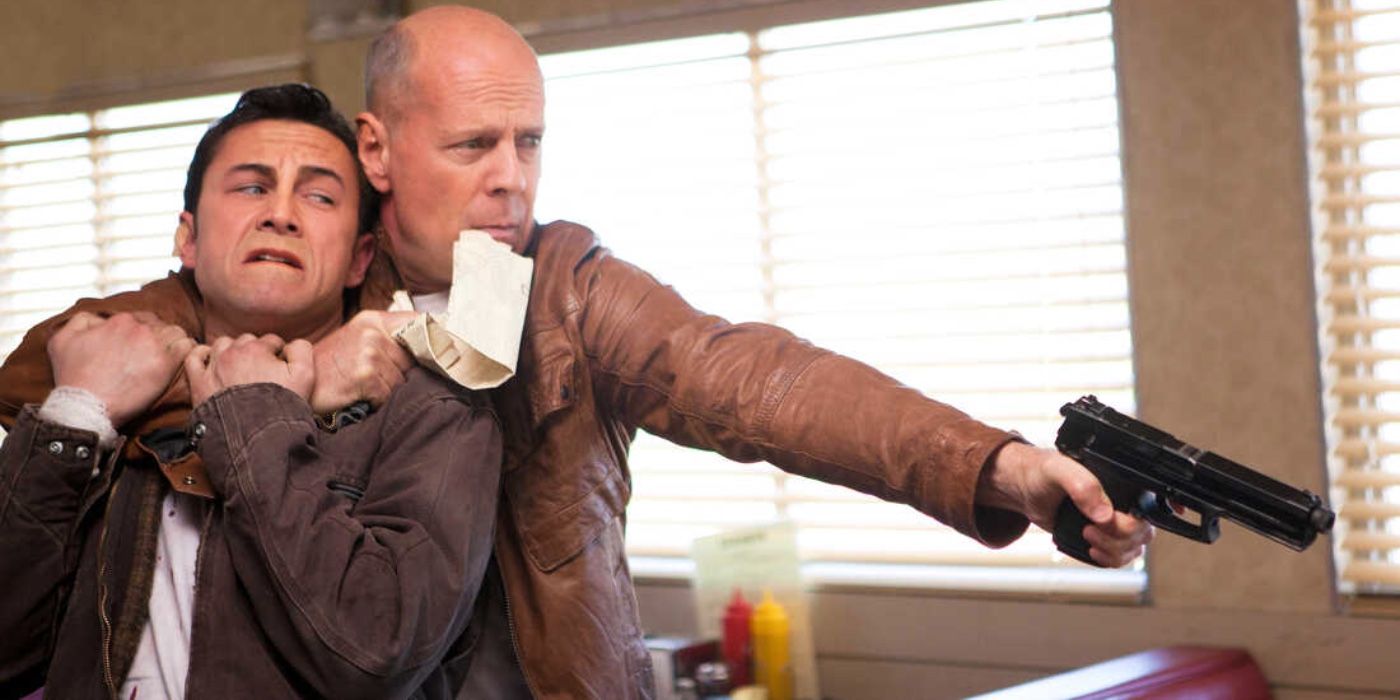 Bruce Willis holding Joseph Gordon Levitt in a headlock in Looper