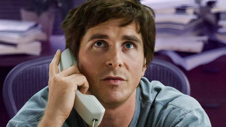 Christian Bale as Michael Burry on the phone, looking up in The Big Short