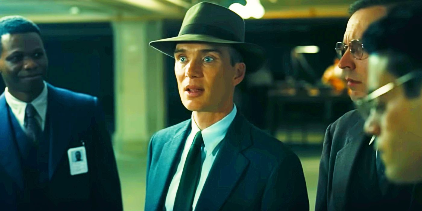 Cillian Murphy's Oppenheimer looking serious while standing with three other men in the movie Oppenheimer.