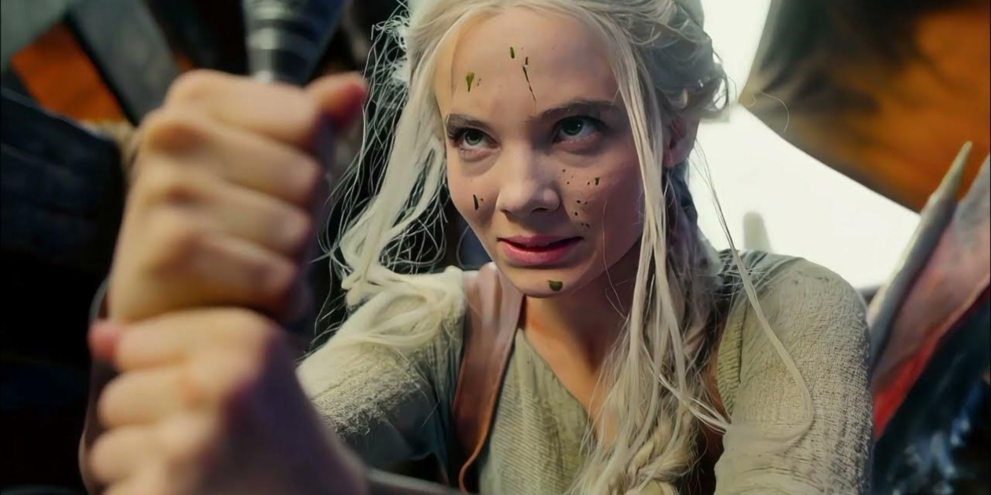 Freya Allan as Ciri looking up with goo on her face in The Witcher