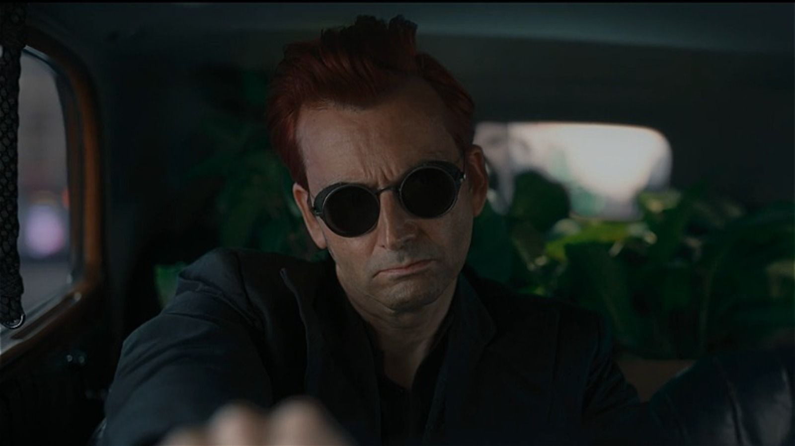 Crowley drives away from the bookshop scowling