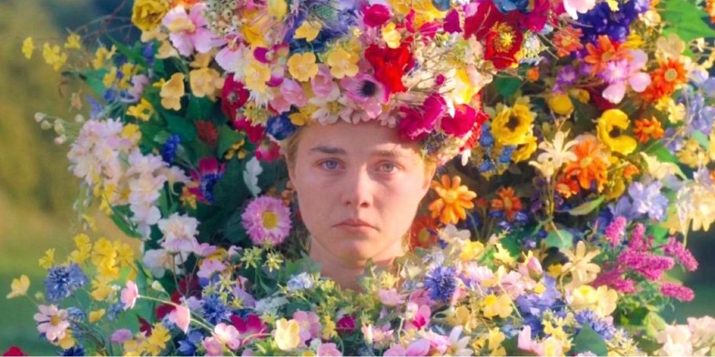 Dani (Florence Pugh) dressed in flowers as the May Queen, frowning, in Midsommar