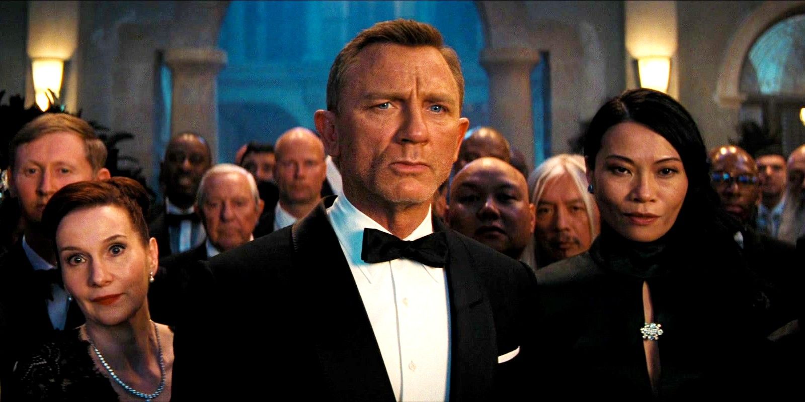 Daniel Craig as James Bond at a party in No Time to Die