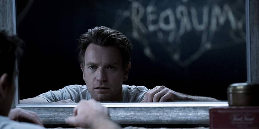 Ewan McGregor as Danny in Doctor Sleep with REDRUM writing behind him