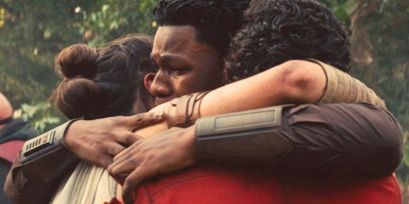 Rey, Finn, and Poe hugging.