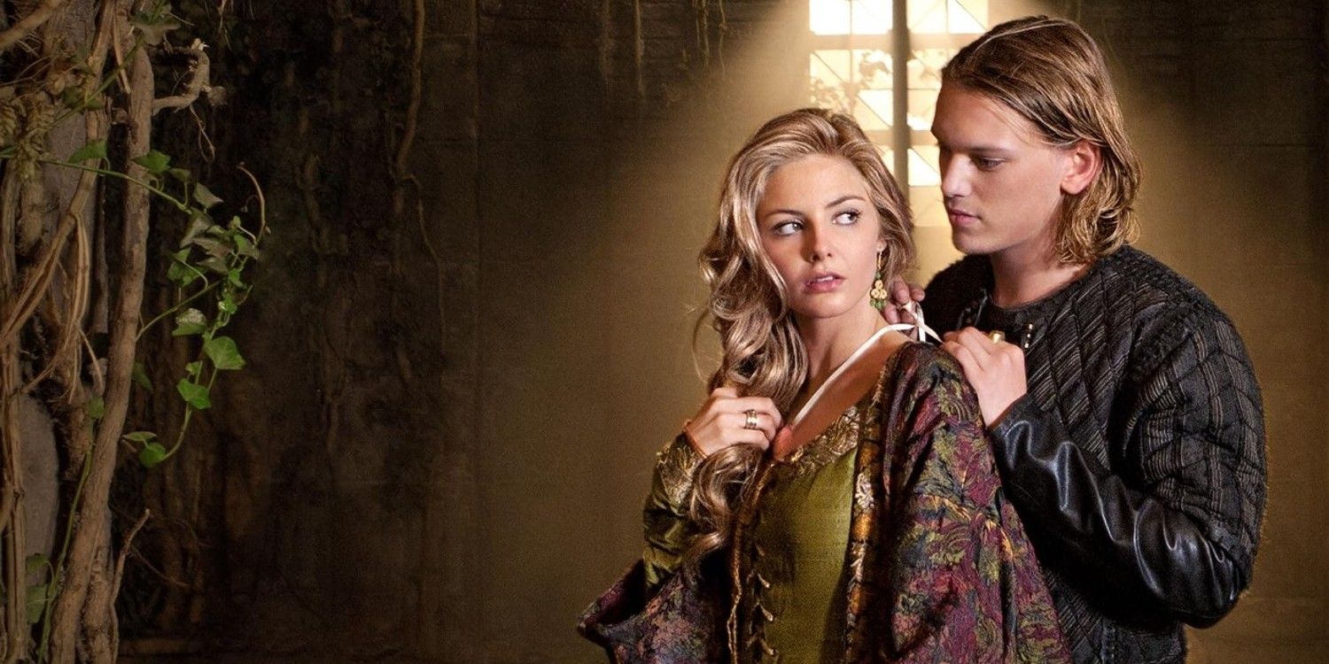 King Arthur and Guinevere stand in a castle in Camelot.