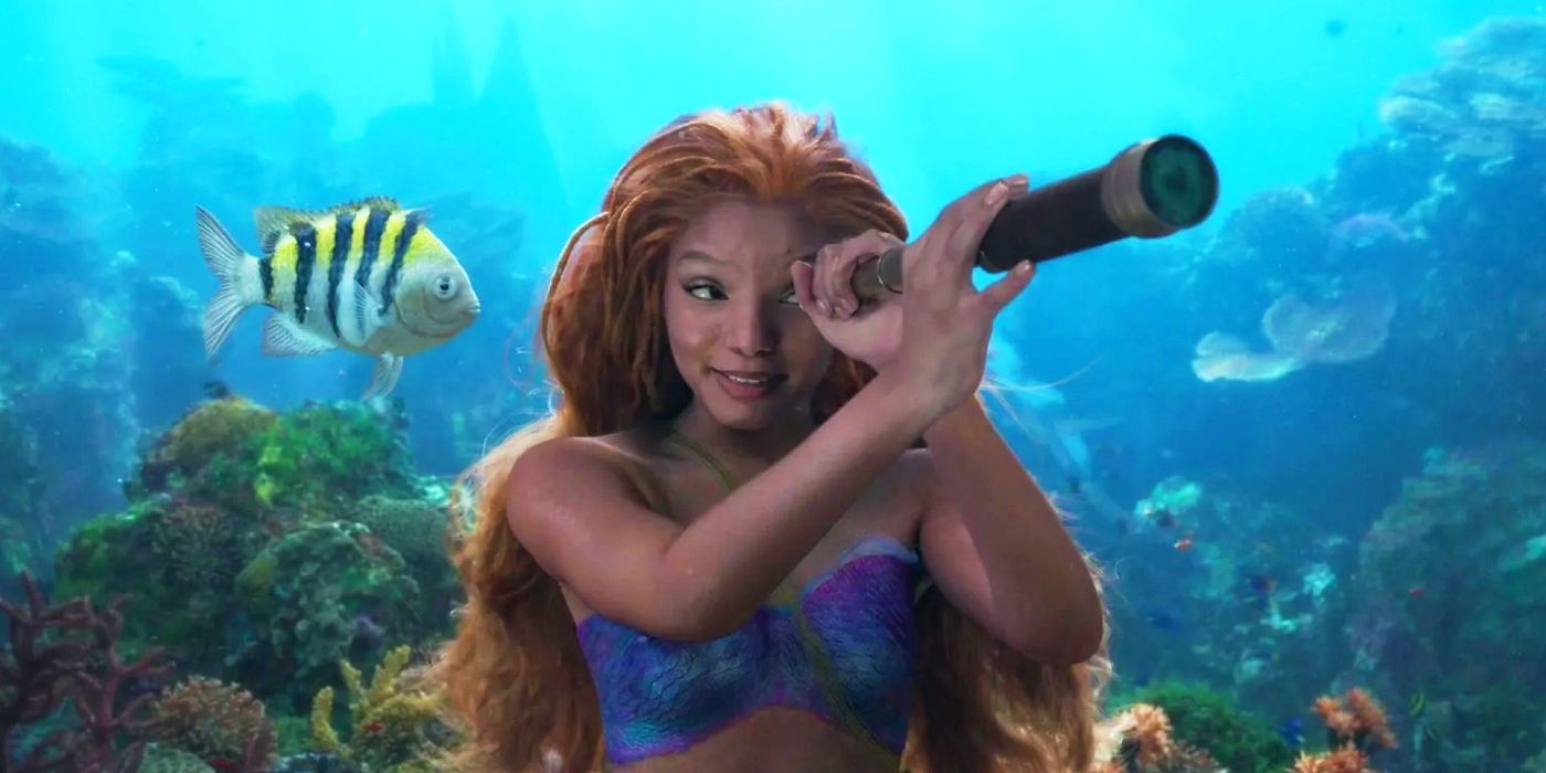 Halle Bailey as Ariel is looking through a telescope in The Little Mermaid.