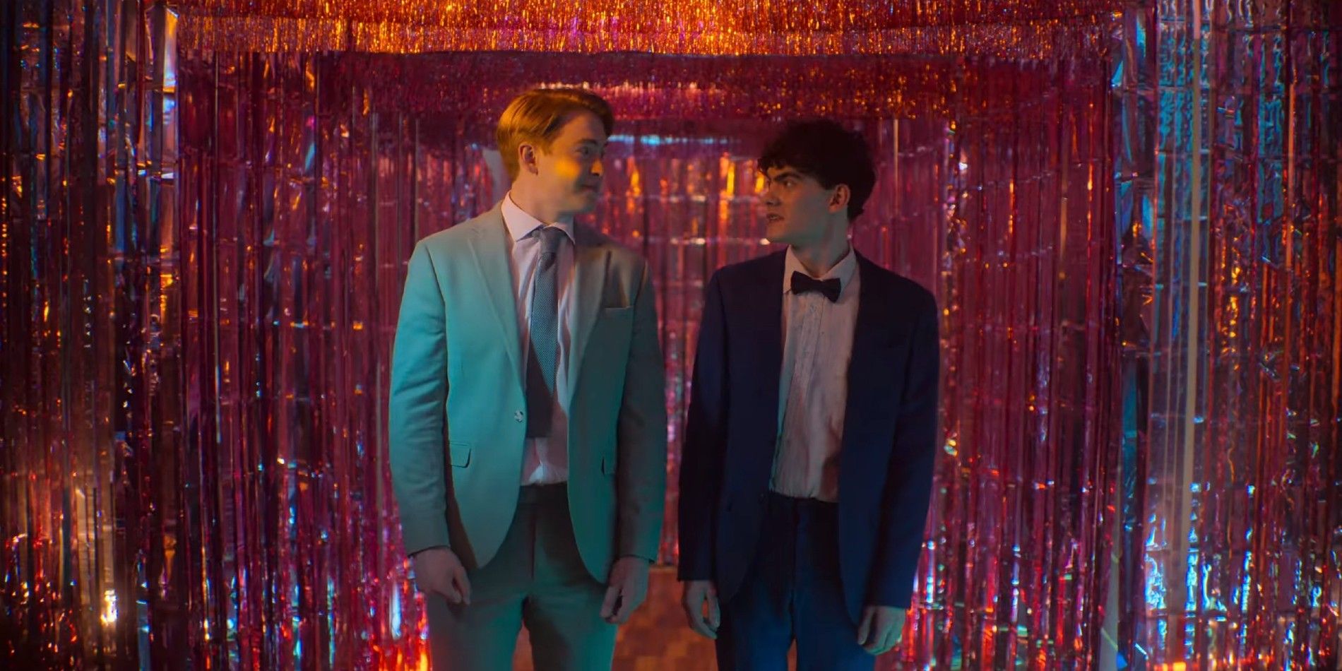 Nick and Charlie smiling at each other at prom in Heartstopper