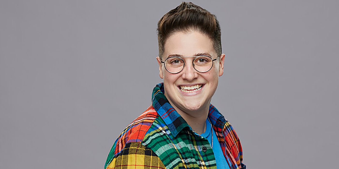 Izzy Gleicher Big Brother in plaid shirt smiling gray background