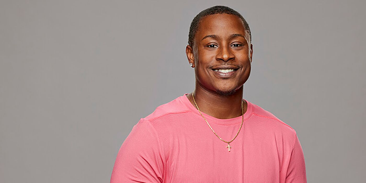 Jared Fields from Big Brother in a pink shirt and smiling, against a gray background