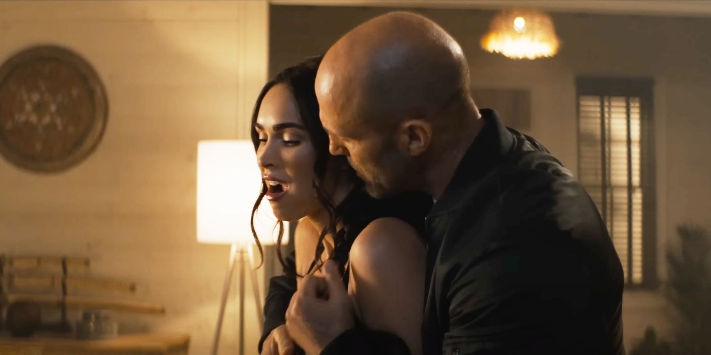 Jason Statham hugging Megan Fox from behind in The Expendables 4.