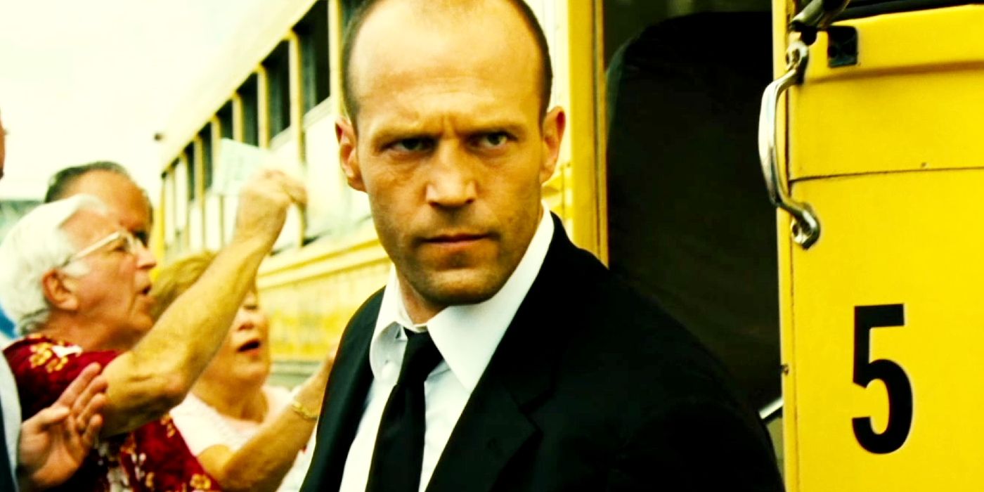 Jason Statham as Frank Martin standing in front of a school bus in Transporter 2.