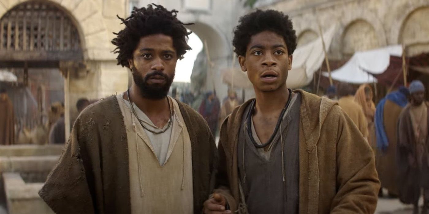 LaKeith Stanfield and RJ Cyler in The Book of Clarence in a street market