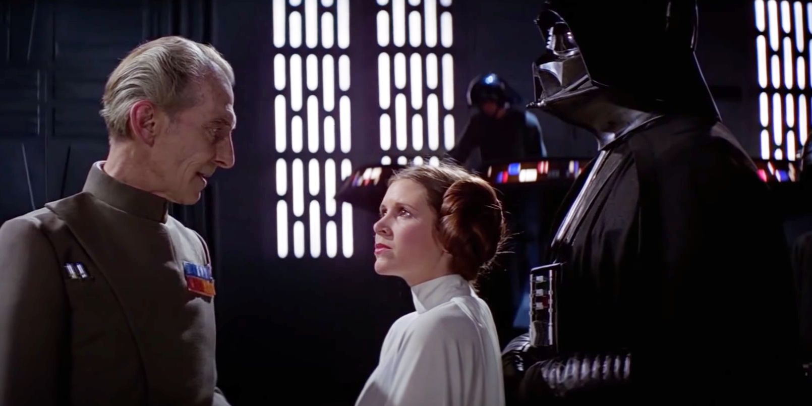 Leia in between Darth Vader and Grand Moff Tarkin in A New Hope