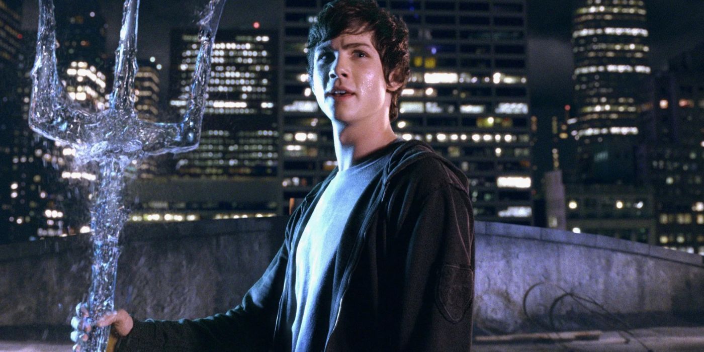 Logan Lerman as Percy Jackson holds water trident in The Lightning Thief
