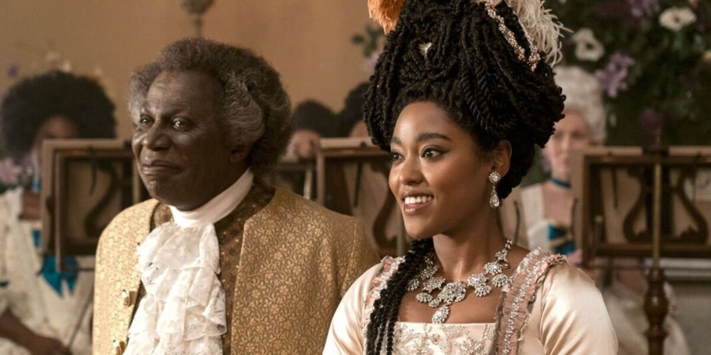 Lord (Cyril Nri) and Lady Danbury (Arsema Thomas) look on in Queen Charlotte: A Bridgerton Story